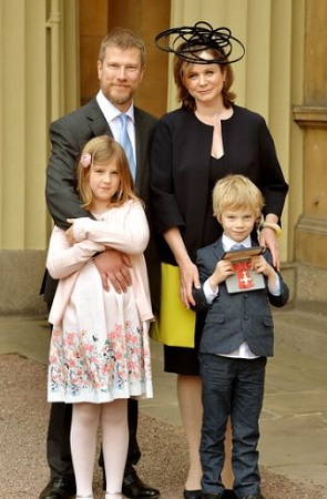 Emily with her husband and kids after receiving the OBE medal
