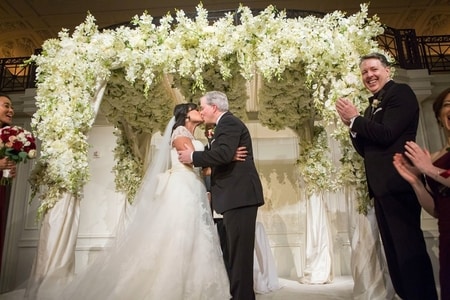 Kristen Welker and John Hughes kissing each other at their wedding