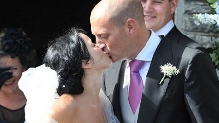 Bret Desmond and Andrea Corr kissing in front of the Church