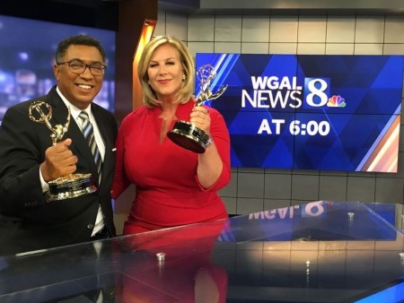 American journalists, Janelle Stelson and Mike Straub holding their Emmy Award