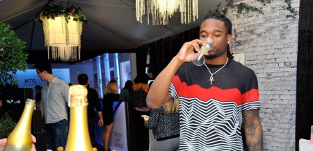 Houston Texans star player, Bradley Roby drinking champagne at the 59th Grammy Awards