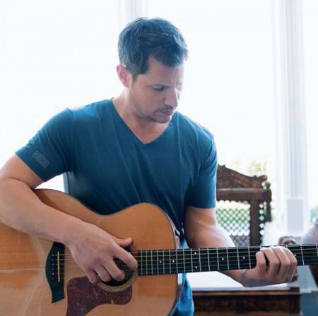 Nick practicing his song in an acoustic guitar. Know more about Nick Lachey age, net worth, parents, family, brother, siblings, marriage, wife, children, songs and many more