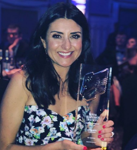 Amy with her award. Know more about her net worth, earnings, income, salary, wages, allowances, total wealth and many more
