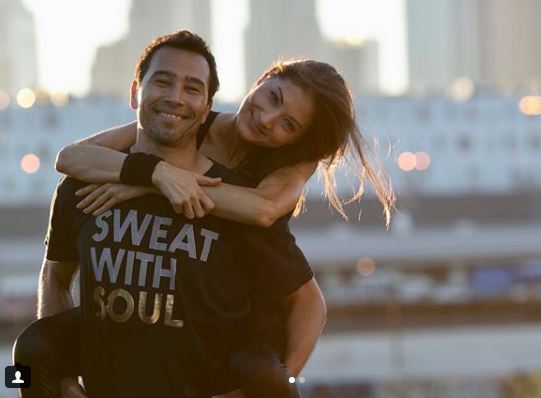 Liberte Chan with her boyfriend Brett Hoebel who is wearing her clothing brand Sweat with Soul