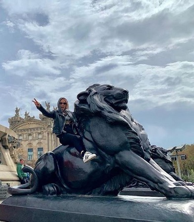 Image: Emma chilling in Barcelona riding on a lion's statue