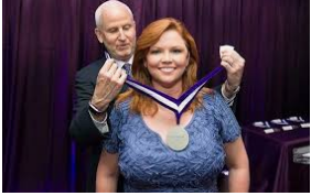 Caption: J.David Ake And His Wife Kelly O'Donnell Having An Honorable Medal For Her Work Source: answersafrica