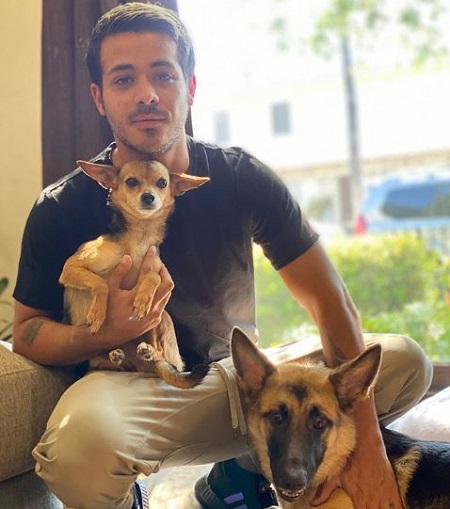 The actor Christian Navarro with his two pet dogs.
