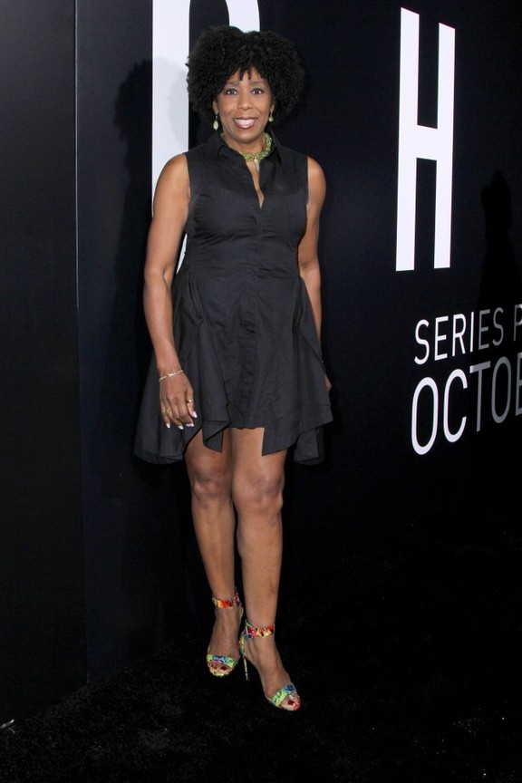 Dawnn Lewis wearing black body cone  with a long ear ring and short black hair