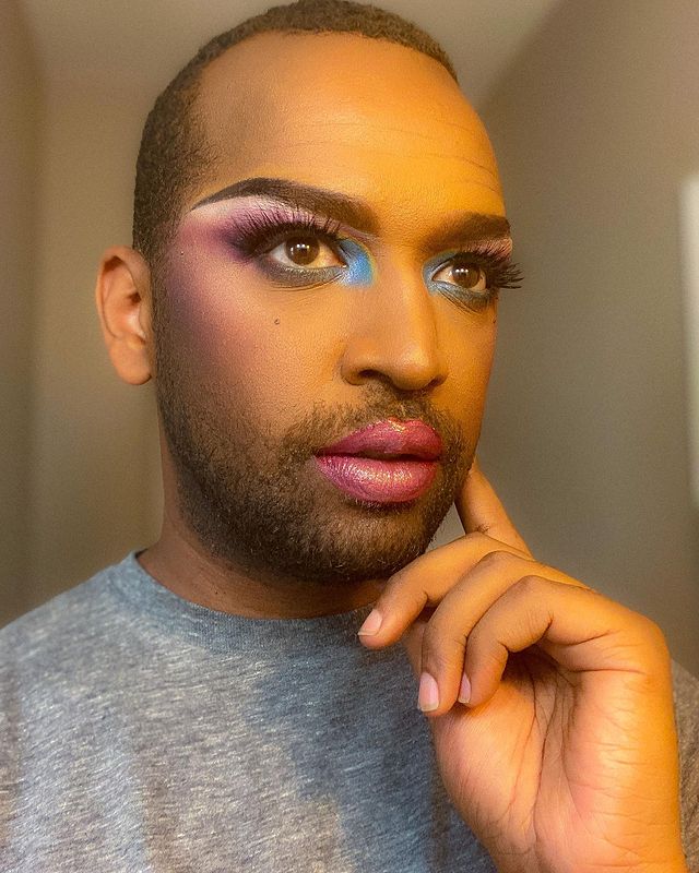 Picture of  Solomon Georgio posing for a photoshoot wearing makeup