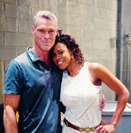 Grayson McCouch posing with his co-star Sharon Leal