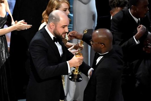 Jordan Horowitz returning the Academy Award to Barry Jenkins