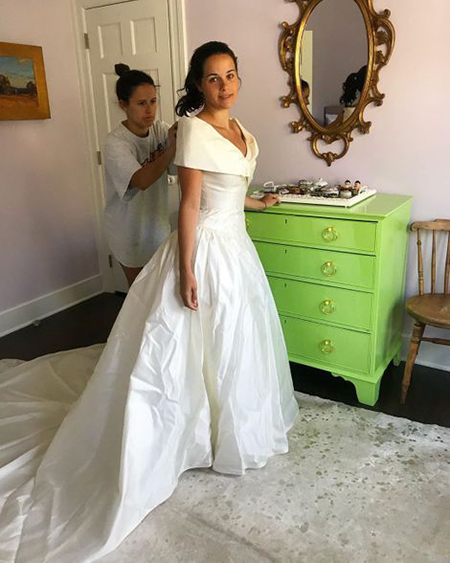 Caroline looks pretty on her mom's wedding dress.