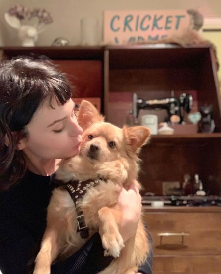 Alexandra Krosney kissing her pet dog, Bear