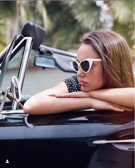 Natalie in a car during her photoshoot