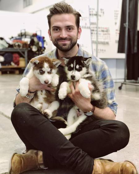 Cameron Cruz with his two Husky puppies