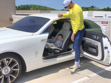 Jayson Christopher Tatum Jr. is sitting under his father's Jayson's lavish car