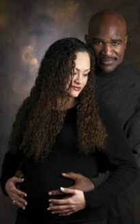 Candi Calvana Smith and her ex-spouse, Evander Holyfield posing for the photo while Candi was pregnant