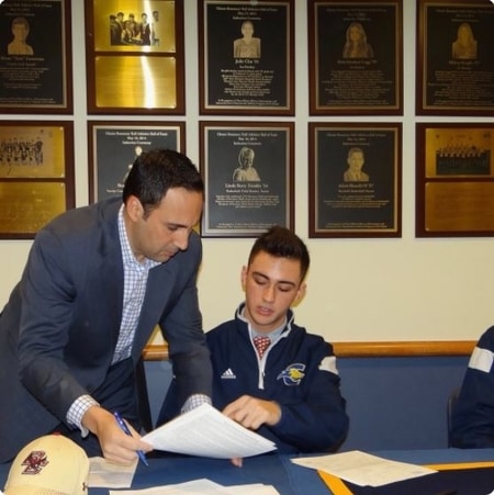 John Tessitore signing a contract with Boston College