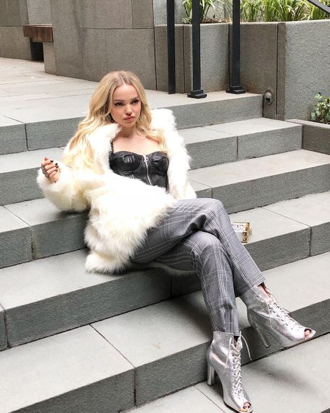 Dove Cameron posing at the stairs