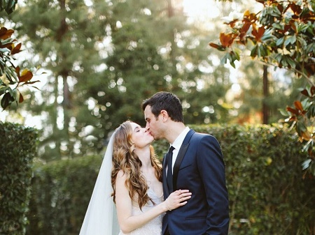 Danielle Panabake kissing her husband, Hayes Robins in the wedding. Know more about Danielle Panabaker marriage, husband, marital life, nuptial and other matrimonial details