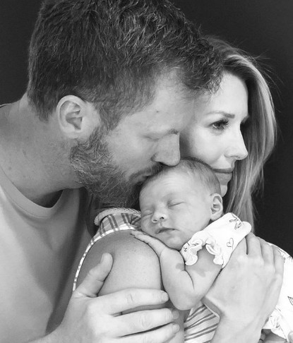 Amy Reimann with her husband and daughter. 