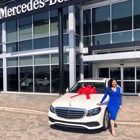 Jennifer Reyna poses on her Mercedes. 
