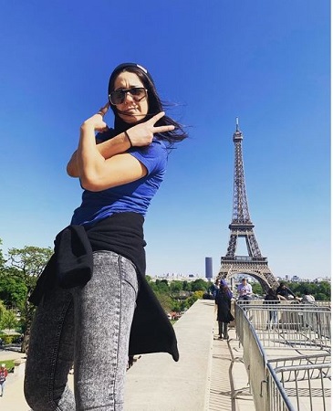 Image: Bayley posing for photo in Eiffel Tower, Paris, France