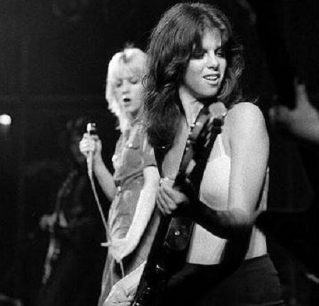 Image: Young Jackie playing bass in the concert alongside with the vocalist, Currie