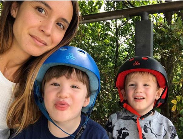 Nicole Centeno with her two sons. One wearing blue helmet and another a red one. 