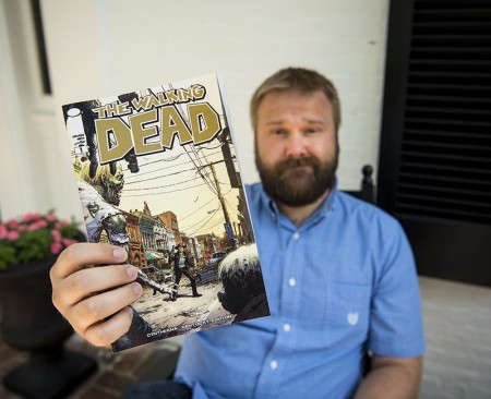 Robert Kirkman showing his comic book, The Walking Dead