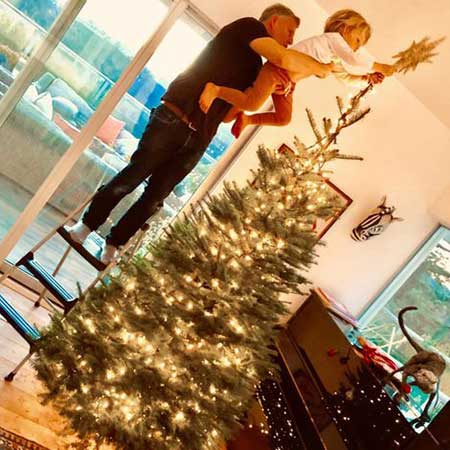 Patrick and his son decorating 2018 Christmas tree.