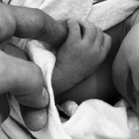 Christina Milian's second child, Isaiah holding his father's finger, Matt Pokora