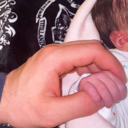 Jack Fincham holding his daughter, Blossom's tiny hands. How old is Jack Fincham's daughter?