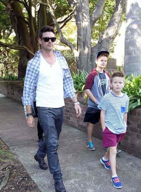 Karl Urban with his two children walking down the park