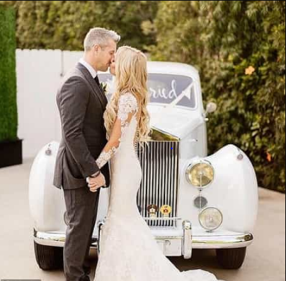 Ant Anstead and Christian kissing in front of a white car on their wedding days