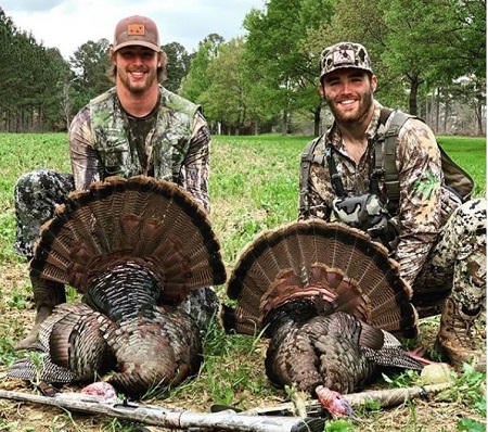 Tyler Fromm (left) went on hunting alongside his brother Jake Fromm.