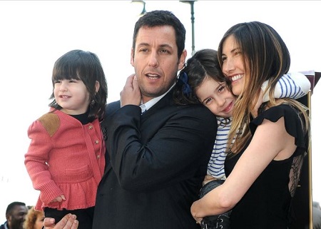 Sadie Sandler (right) with her mother Jackie, father Adam, and the younger sister Sunny Sandler.