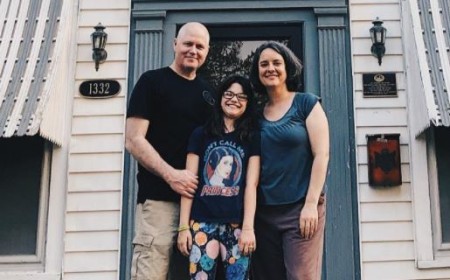 Sasha, her husband, Keith and Ava posing in front of their home in Tulsa.