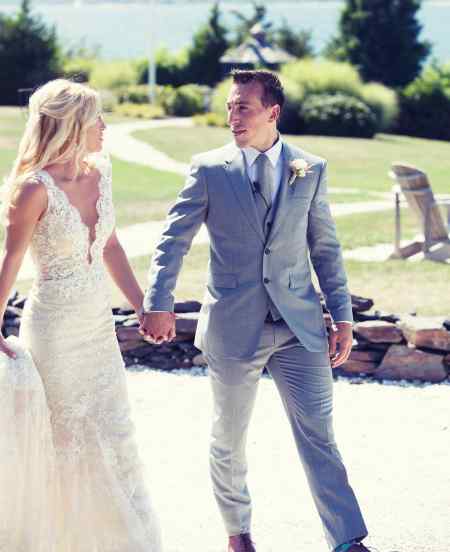 Katrina Sloane and Brad Marchand holding hands in their grand nuptial. Know more in details about the couple's wedding ceremony.