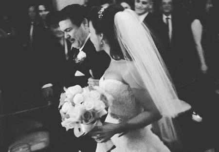 Lacey Chabert alongside her father walking down the aisle at her wedding