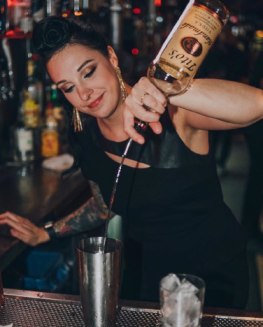 Lisamarie Joyce making a cocktail for her customer at her bar