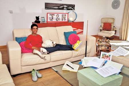 James Hagger's wife, Naga Munchetty sitting on the couch with her two cats, Kinky and Ronnie. Find more interesting things about Munchetty and Hagger's marital life.