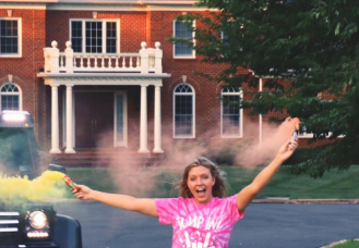 Grace Sharer picturing in front of her lavish house which has quite a value in 6 figure.