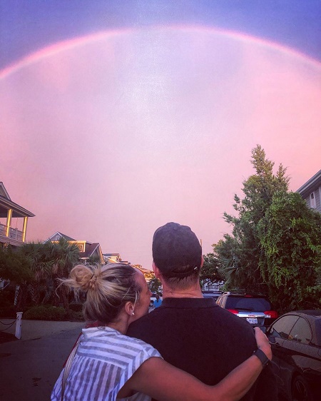 Lauryn Ricketts Posted a Picture with Husband, Eric Earnhardt on Instagram infont of a  Rainbow