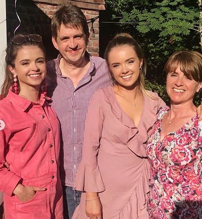 Emily with her parents and sister, enjoying a healthy life.