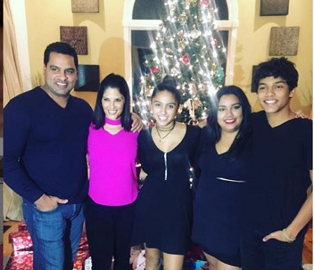 Darlene Rodriguez (pink dress) with her husband David, and children David Jake (right), Natalia (third in the row), and Katina Rodriguez (second from right). 