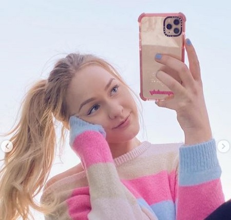 The Instagram star Maddy Spidell poses on her I-Phone 11 Pro Max.