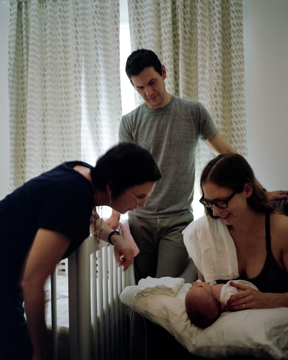 Tom and his wife Shannon pose with their  newly born daughter Sasha and their postpartum doula. 
