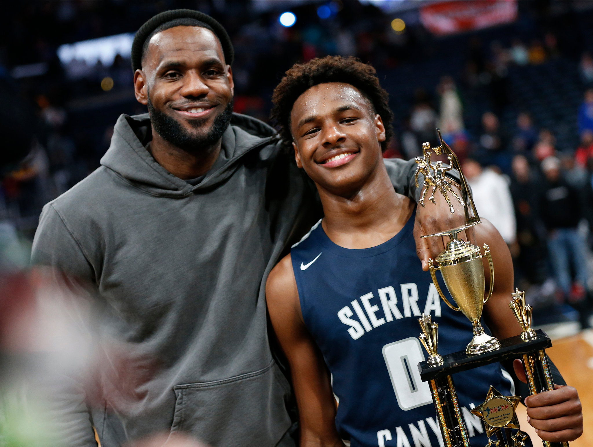 The rising young and talented basketball player, Bronny holding an troupe for Sierra Canyon School with his father, Lebron. 