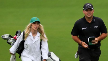 Justine on the field carrying bags for Patrick as his caddie.